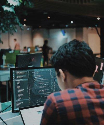 a worker huched over a workstation